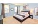 Light and airy main bedroom features a large window, carpet, and modern decor at 2555 Shanti Dr, Kissimmee, FL 34746