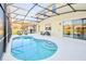 Inviting screened-in pool area with comfortable seating and scenic backyard views from inside a lovely, well-lit home at 2555 Shanti Dr, Kissimmee, FL 34746