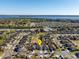 High-angle aerial showcasing a serene neighborhood with a lake view and a pin highlighting the property's location at 2665 Rotherham Rd, Tavares, FL 32778