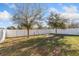 A large fenced backyard offering ample space for recreation and gardening possibilities at 2665 Rotherham Rd, Tavares, FL 32778