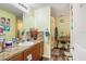 Bathroom featuring a well-lit vanity area with decorative countertops, and a separate area with shower and dressing table at 2665 Rotherham Rd, Tavares, FL 32778
