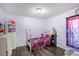 Bright and charming bedroom with whimsical decorations, a white wicker dresser, and a cozy bed at 2665 Rotherham Rd, Tavares, FL 32778