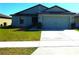 Charming single-story home with a well-maintained lawn and a two-car garage at 2665 Rotherham Rd, Tavares, FL 32778