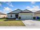 Charming single-story home featuring a well-maintained lawn and a two-car garage at 2665 Rotherham Rd, Tavares, FL 32778