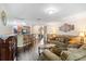 An open-concept living room flows into the kitchen, complete with breakfast bar, wood floors, and stylish decor at 2665 Rotherham Rd, Tavares, FL 32778