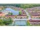 Scenic aerial view of the Regal Oaks community featuring a lake, pool, tennis court, and lush landscaping at 2706 Bushman Dr, Kissimmee, FL 34746