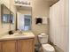 This bathroom features a sink, toilet, shower, and a large mirror at 2706 Bushman Dr, Kissimmee, FL 34746