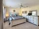Spacious bedroom featuring a ceiling fan, wooden furniture set, and gray and blue accents at 2706 Bushman Dr, Kissimmee, FL 34746