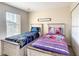 This bedroom features two twin beds, a window and a closet at 2706 Bushman Dr, Kissimmee, FL 34746
