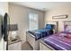 Cozy bedroom with twin beds, a nightstand, and a window for natural light at 2706 Bushman Dr, Kissimmee, FL 34746