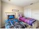 bedroom featuring two twin beds with themed bedding and a closet with white doors at 2706 Bushman Dr, Kissimmee, FL 34746