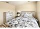 Bedroom with a floral duvet cover, white nightstand, and a chest of drawers with white accents at 2706 Bushman Dr, Kissimmee, FL 34746