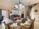 Inviting dining space leading to the living room with comfortable seating and sliding door access to the patio at 2706 Bushman Dr, Kissimmee, FL 34746