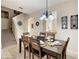 Dining room with a table set for six, chandelier, and staircase at 2706 Bushman Dr, Kissimmee, FL 34746