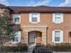 Inviting townhouse exterior with neutral tones, decorative trim, and well-maintained landscaping at 2706 Bushman Dr, Kissimmee, FL 34746