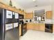 Functional kitchen featuring wood cabinetry, black appliances, and ample counter space at 2706 Bushman Dr, Kissimmee, FL 34746