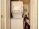 This laundry closet features a stacked washer and dryer and ample space for supplies at 2706 Bushman Dr, Kissimmee, FL 34746