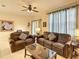 Spacious living room featuring leather sofas, decorative pillows, and ample natural light at 2706 Bushman Dr, Kissimmee, FL 34746