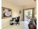Living room featuring a leather sofa, desk, and sliding doors to an outdoor patio at 2706 Bushman Dr, Kissimmee, FL 34746