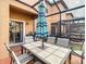 This screened-in patio features an outdoor dining table with chairs and an umbrella at 2706 Bushman Dr, Kissimmee, FL 34746