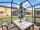 The screened-in patio features an outdoor dining table with seating for six at 2706 Bushman Dr, Kissimmee, FL 34746