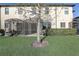 View of a backyard featuring a well-maintained lawn and screened lanai, providing a private outdoor space at 2725 Econ Landing Blvd, Orlando, FL 32825