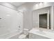 Clean and well-lit bathroom with white tiles, modern fixtures, and a spacious bathtub at 2725 Econ Landing Blvd, Orlando, FL 32825