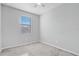 Bright bedroom features neutral paint, carpet, ceiling fan, and a window for natural light at 2725 Econ Landing Blvd, Orlando, FL 32825