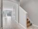 Inviting foyer featuring neutral tile flooring, staircase access, and an open view to the living area at 2725 Econ Landing Blvd, Orlando, FL 32825