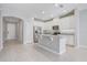 Well-lit kitchen featuring white cabinets, stainless steel appliances, and a granite countertop island at 2725 Econ Landing Blvd, Orlando, FL 32825