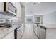 Well-appointed kitchen featuring stainless steel appliances, granite countertops and central island and sink at 2725 Econ Landing Blvd, Orlando, FL 32825