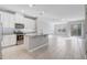 Modern kitchen featuring granite countertops, white cabinets, stainless steel appliances, and an island with sink at 2725 Econ Landing Blvd, Orlando, FL 32825