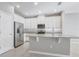 Bright kitchen features stainless steel appliances, granite countertops, white cabinets, and a central island at 2725 Econ Landing Blvd, Orlando, FL 32825