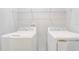 Functional laundry room with modern side-by-side washer and dryer units at 2725 Econ Landing Blvd, Orlando, FL 32825