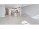 Open-concept living room flows into a kitchen with white cabinets and stainless steel appliances at 2725 Econ Landing Blvd, Orlando, FL 32825