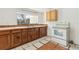 Kitchen with wood cabinets, tile countertops, tile floors, and white oven at 27630 Jean Ave, Paisley, FL 32767
