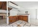 Open kitchen features wood cabinets, breakfast bar, and a decorative brick fireplace at 27630 Jean Ave, Paisley, FL 32767