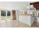 Open kitchen features a bar and pass-through to the living room, wood cabinets, and sliding glass doors at 27630 Jean Ave, Paisley, FL 32767