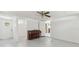 Neutral living area features a piano, ceiling fan, and access to other rooms at 27630 Jean Ave, Paisley, FL 32767