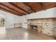 Living room features wood ceiling, fireplace, light wood flooring, and a large window at 27630 Jean Ave, Paisley, FL 32767