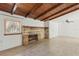 Living room features wood ceiling, fireplace, light wood flooring, and a large window at 27630 Jean Ave, Paisley, FL 32767