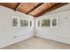 Inviting living space featuring wood beam ceiling and natural light from the windows, creating a cozy ambiance at 27630 Jean Ave, Paisley, FL 32767
