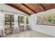 Bright sunroom with wood ceiling, large windows, natural lighting, and wood floors at 27630 Jean Ave, Paisley, FL 32767