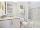 Bathroom showcasing a tub with tiled walls, a marble countertop vanity, and a well-lit space at 280 Burma St, Kissimmee, FL 34747