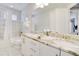 Well-lit bathroom with marble countertops and dual sinks, complemented by stylish fixtures and tile at 280 Burma St, Kissimmee, FL 34747