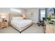 Bedroom featuring tufted headboard, two large windows, and gray accent chair at 280 Burma St, Kissimmee, FL 34747