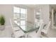 Bright dining room with marble floors and a large glass table with seating for six at 280 Burma St, Kissimmee, FL 34747