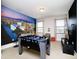 Game room featuring a cityscape mural, foosball table, and comfortable seating for fun gatherings at 280 Burma St, Kissimmee, FL 34747