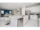 Spacious kitchen featuring a large center island, white cabinets, and stainless-steel appliances in an open concept floor plan at 280 Burma St, Kissimmee, FL 34747