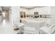Open kitchen featuring marble counters, white cabinets, stainless steel appliances and seating at the island at 280 Burma St, Kissimmee, FL 34747